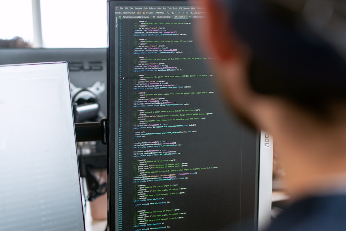 Source code on a monitor, read over a developer’s shoulder