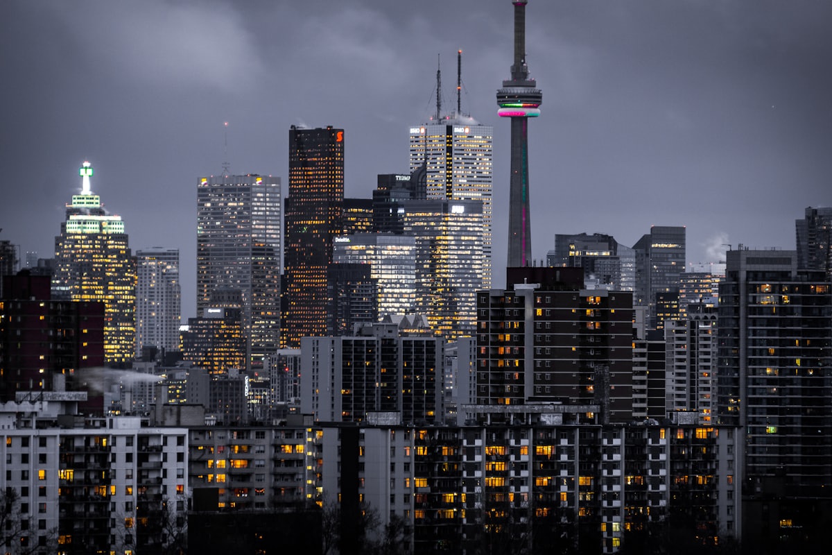 A city skyline at dusk with office towers lit from within